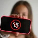 Teenager using a smartphone as the Turkey social media ban for under-15s takes effect on November 1