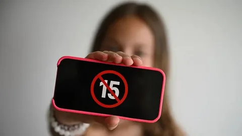 Teenager using a smartphone as the Turkey social media ban for under-15s takes effect on November 1